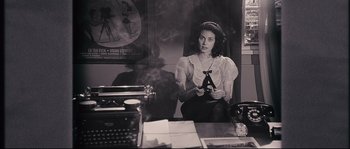 Movie still from “The Black Dahlia” (2006), directed by Brian De Palma – A woman sitting in front of an old fashioned typewriter; Medium shot, High angle