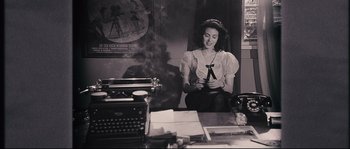 Movie still from “The Black Dahlia” (2006), directed by Brian De Palma – A woman sitting in front of an old fashioned typewriter; Medium shot, High angle