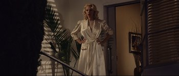 Movie still from “The Black Dahlia” (2006), directed by Brian De Palma – A woman standing on a staircase wearing a white dress; Medium shot, Low angle