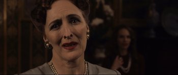Movie still from “The Black Dahlia” (2006), directed by Brian De Palma – An older woman with a sad look on her face; Close Up shot, Over the shoulder angle