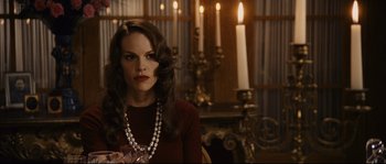 Movie still from “The Black Dahlia” (2006), directed by Brian De Palma – A woman with long dark hair wearing a red sweater; Medium shot, Over the shoulder angle