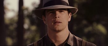 Movie still from “The Black Dahlia” (2006), directed by Brian De Palma – A young man wearing a hat and a brown shirt; Close Up shot, Low angle