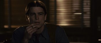 Movie still from “The Black Dahlia” (2006), directed by Brian De Palma – A man smoking a cigarette while wearing a tie; Close Up shot, Over the shoulder angle