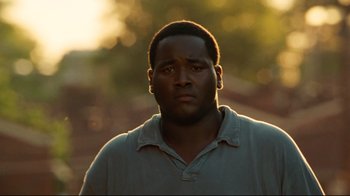 Movie still from “The Blind Side” (2009), directed by John Lee Hancock – A person wearing a polo shirt; Close Up shot, Low angle