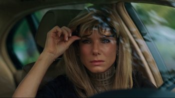 Movie still from “The Blind Side” (2009), directed by John Lee Hancock – A woman sitting in the back seat of a car; Close Up shot, Over the shoulder angle