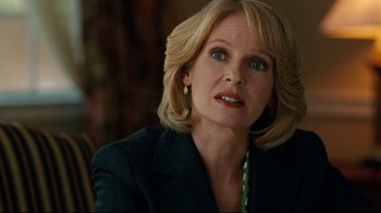 Movie still from “The Blind Side” (2009), directed by John Lee Hancock – A person wearing a suit; Close Up shot, Over the shoulder angle