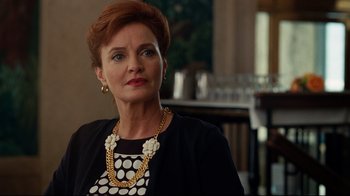 Movie still from “The Blind Side” (2009), directed by John Lee Hancock – An older woman wearing a black and white polka dot shirt; Close Up shot, Over the shoulder angle