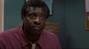 Movie still from “The Blind Side” (2009), directed by John Lee Hancock – A person wearing a shirt and a tie; Close Up shot, Low angle