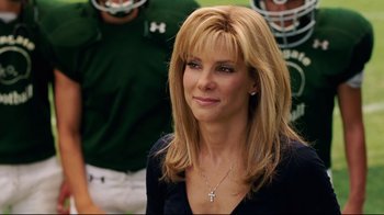 Movie still from “The Blind Side” (2009), directed by John Lee Hancock – A person wearing a necklace; Close Up shot, Over the shoulder angle