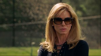 Movie still from “The Blind Side” (2009), directed by John Lee Hancock – A woman wearing sunglasses and a black jacket; Close Up shot, Low angle
