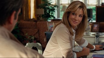 Movie still from “The Blind Side” (2009), directed by John Lee Hancock – A woman sitting at a table in a living room; Close Up shot, Over the shoulder angle