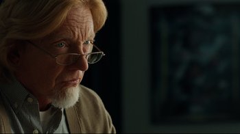 Movie still from “The Blind Side” (2009), directed by John Lee Hancock – An old man with a beard wearing glasses and wearing a tie; Close Up shot, Over the shoulder angle