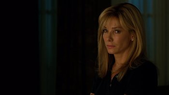 Movie still from “The Blind Side” (2009), directed by John Lee Hancock – A woman with long blonde hair is looking at the camera; Close Up shot, Over the shoulder angle