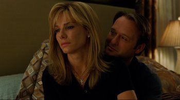 Movie still from “The Blind Side” (2009), directed by John Lee Hancock – A man and a woman sitting next to each other in a room; Close Up shot, Over the shoulder angle