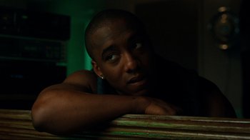 Movie still from “The Blind Side” (2009), directed by John Lee Hancock – A person leaning on a table; Close Up shot, Low angle
