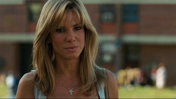 Movie still from “The Blind Side” (2009), directed by John Lee Hancock – A person wearing a necklace; Close Up shot, Over the shoulder angle
