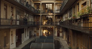 Movie still from “The Boy in the Striped Pajamas” (2008), directed by Mark Herman – A group of people standing inside of an apartment building; Extreme Wide shot, High angle