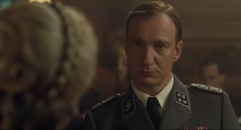 Movie still from “The Boy in the Striped Pajamas” (2008), directed by Mark Herman – A person wearing a uniform; Close Up shot, Over the shoulder angle