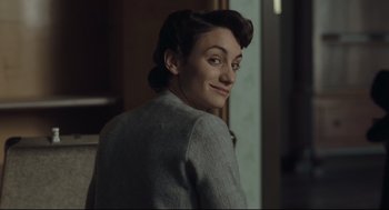 Movie still from “The Boy in the Striped Pajamas” (2008), directed by Mark Herman – A woman in a gray jacket is looking at the camera; Close Up shot, Over the shoulder angle