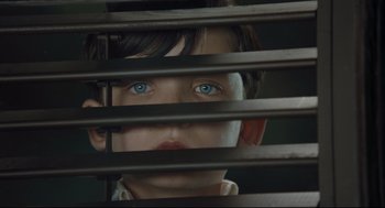 Movie still from “The Boy in the Striped Pajamas” (2008), directed by Mark Herman – A young boy looking through the blinds of a window; Close Up shot, Overhead angle