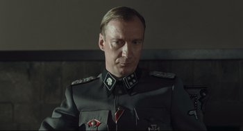 Movie still from “The Boy in the Striped Pajamas” (2008), directed by Mark Herman – A person wearing a uniform; Close Up shot, Over the shoulder angle