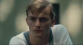 Movie still from “The Boy in the Striped Pajamas” (2008), directed by Mark Herman – A person wearing a white t - shirt; Close Up shot, Low angle