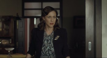 Movie still from “The Boy in the Striped Pajamas” (2008), directed by Mark Herman – A woman wearing a black jacket standing in front of a window; Medium shot, Over the shoulder angle