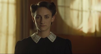 Movie still from “The Boy in the Striped Pajamas” (2008), directed by Mark Herman – A woman in a black and white dress with a white collar; Close Up shot, Over the shoulder angle