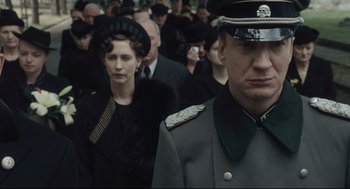 Movie still from “The Boy in the Striped Pajamas” (2008), directed by Mark Herman – A group of people that are standing in the street; Close Up shot, Over the shoulder angle