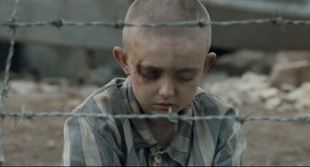 Movie still from “The Boy in the Striped Pajamas” (2008), directed by Mark Herman – A young boy with bandages on his head and face; Close Up shot, High angle
