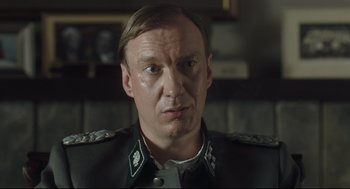 Movie still from “The Boy in the Striped Pajamas” (2008), directed by Mark Herman – A person wearing a uniform; Close Up shot, Over the shoulder angle