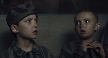 Movie still from “The Boy in the Striped Pajamas” (2008), directed by Mark Herman – Two young boys in military uniforms looking at something; Close Up shot, Over the shoulder angle