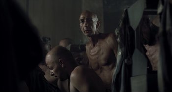 Movie still from “The Boy in the Striped Pajamas” (2008), directed by Mark Herman – A group of men sitting in a room together; Medium shot, Over the shoulder angle