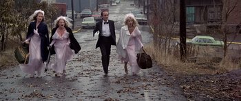 Movie still from “The Deer Hunter” (1978), directed by Michael Cimino – A man and a woman walking down a street; Wide shot, High angle