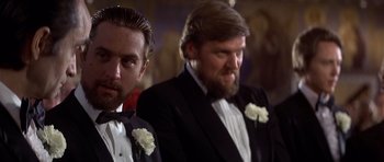 Movie still from “The Deer Hunter” (1978), directed by Michael Cimino – Two men in tuxedos with white flowers in their tuxedos; Close Up shot, Low angle