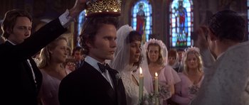 Movie still from “The Deer Hunter” (1978), directed by Michael Cimino – A man and a woman standing next to each other in front of candles; Close Up shot, Low angle
