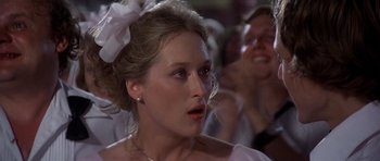 Movie still from “The Deer Hunter” (1978), directed by Michael Cimino – A person wearing a dress; Close Up shot, Over the shoulder angle
