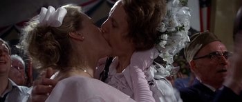 Movie still from “The Deer Hunter” (1978), directed by Michael Cimino – Two women kissing each other on the cheek; Close Up shot, Over the shoulder angle