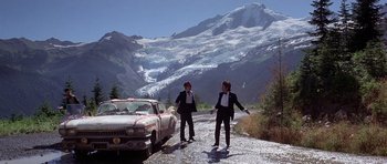 Movie still from “The Deer Hunter” (1978), directed by Michael Cimino – A couple of people standing next to a car; Wide shot, Low angle