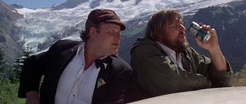 Movie still from “The Deer Hunter” (1978), directed by Michael Cimino – Two men sitting next to each other on top of a hill; Medium shot, High angle