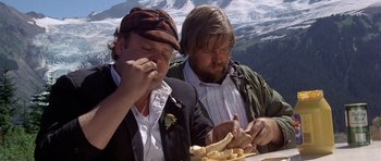 Movie still from “The Deer Hunter” (1978), directed by Michael Cimino – Two men sitting at a table eating food; Close Up shot, High angle