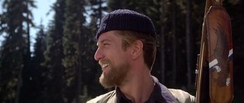 Movie still from “The Deer Hunter” (1978), directed by Michael Cimino – A person with a beard wearing a hat; Close Up shot, Over the shoulder angle