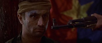 Movie still from “The Deer Hunter” (1978), directed by Michael Cimino – A person with a gun; Close Up shot, Low angle