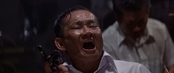 Movie still from “The Deer Hunter” (1978), directed by Michael Cimino – An older man is crying while holding a cell phone; Close Up shot, Low angle