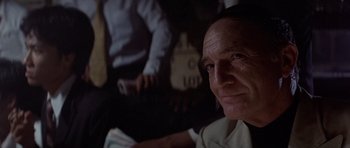 Movie still from “The Deer Hunter” (1978), directed by Michael Cimino – An older man sitting in front of another man; Close Up shot, Over the shoulder angle