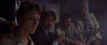 Movie still from “The Deer Hunter” (1978), directed by Michael Cimino – A group of men sitting next to each other in a room; Close Up shot, Over the shoulder angle