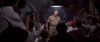 Movie still from “The Deer Hunter” (1978), directed by Michael Cimino – A group of people gathered around a man in uniform; Medium shot, Low angle
