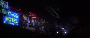 Movie still from “The Deer Hunter” (1978), directed by Michael Cimino – A car parked on the side of the road at night; Extreme Wide shot, Low angle