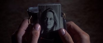 Movie still from “The Deer Hunter” (1978), directed by Michael Cimino – A person holding an old photo of a woman; Close Up shot, Over the shoulder angle