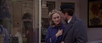 Movie still from “The Deer Hunter” (1978), directed by Michael Cimino – A man and a woman standing next to each other in front of a building; Close Up shot, Over the shoulder angle